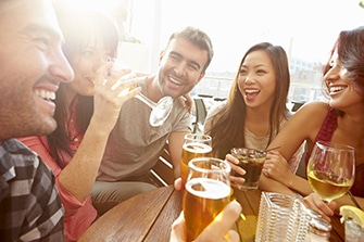 A Handful of people drinking alcohol and smiling. Buy why do people drink alcohol?