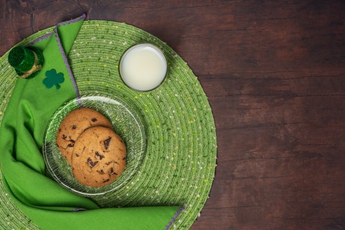 St. Patrick's day themed desert of cookies and milk.