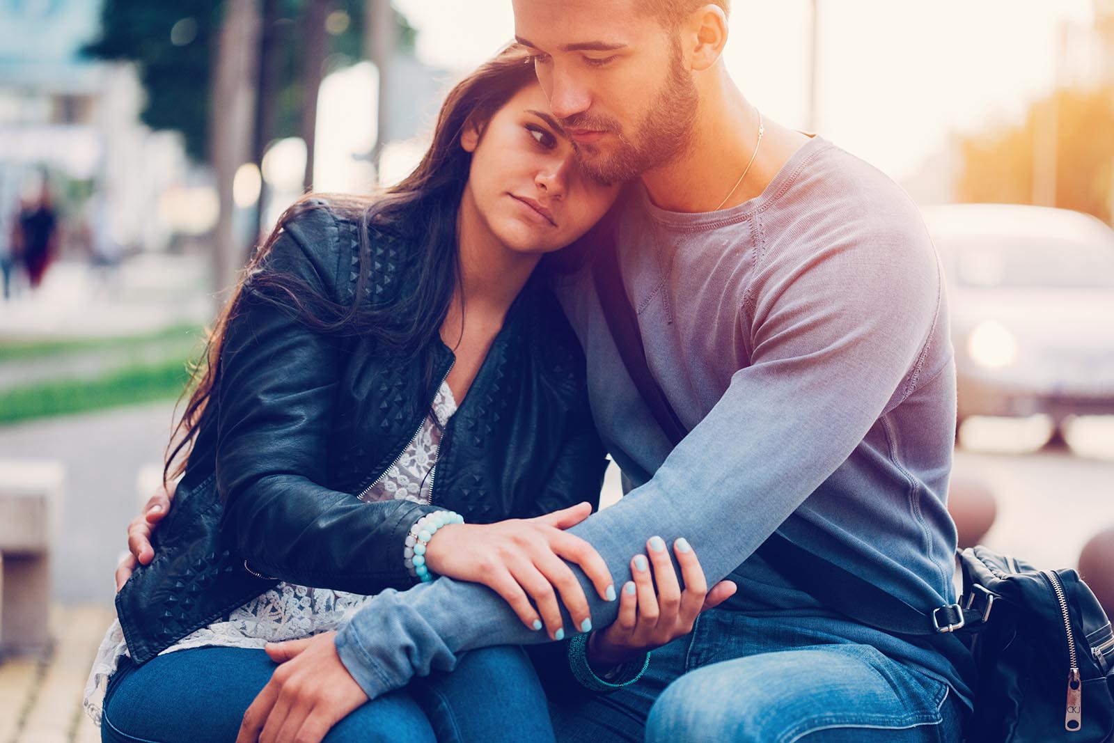 Young man sitting down and consoling his girlfriend, when to know you're ready for alcohol treatment.