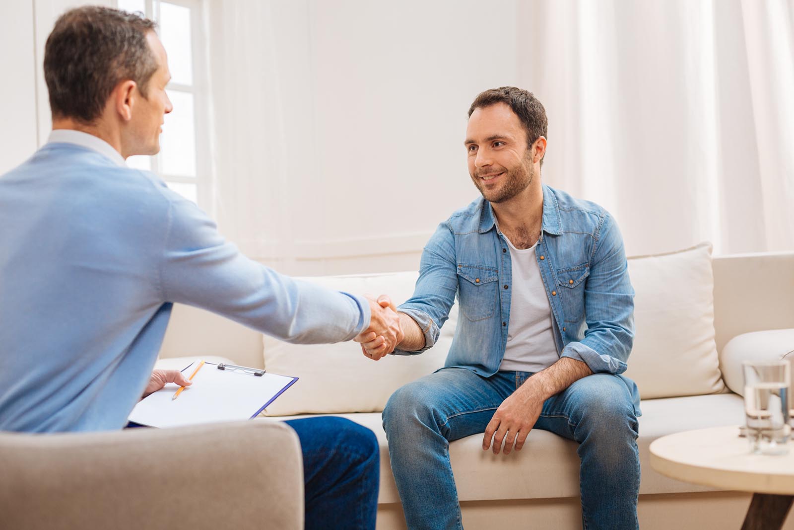 Two men shaking hands after a successful treatment program at Cliffside Malibu, in Malibu, California.