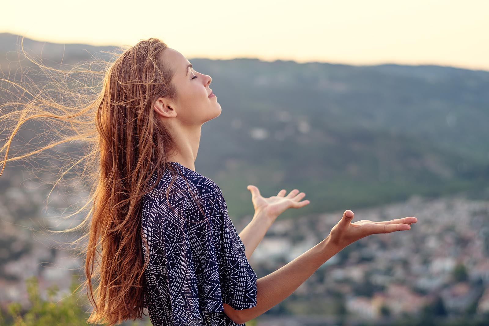 What to expect from Detox at Cliffside Malibu, a woman overlooking the view in Malibu, California.