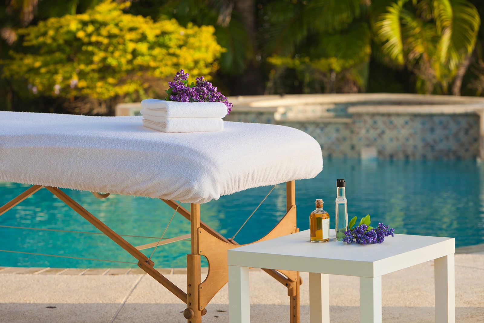 Massage table in front of the pool at Cliffside Malibu, an addiction treatment center in Malibu, California.
