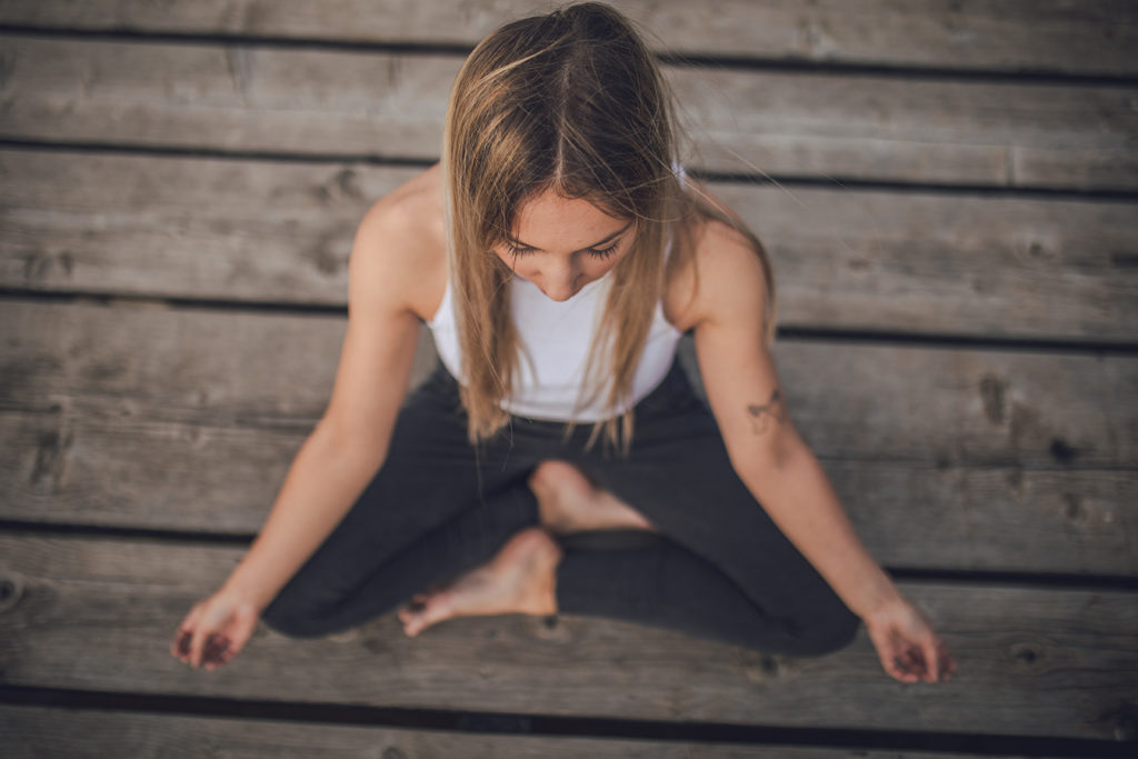 Woman doing yoga and practicing mindsight at Cliffside Malibu, an addiction treatment center in Malibu, California.