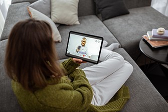 How to be There for a Loved One in Recovery During Social Distancing, girl on her laptop talking to a loved one.