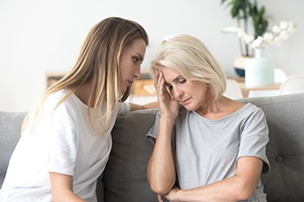 What to Say to a Loved One When They Are in Denial About Alcohol Addiction, a daughter having a conversation with mother on the couch.