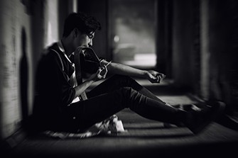 Substance Use Disorder in the United States, man sitting on the street.