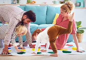 Social Distancing and Quarantine During Coronavirus: Looking at the Bright Side, parents playing Twister with two children.
