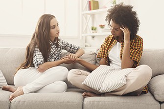 How to Help an Alcoholic, two people sitting on a couch talking.