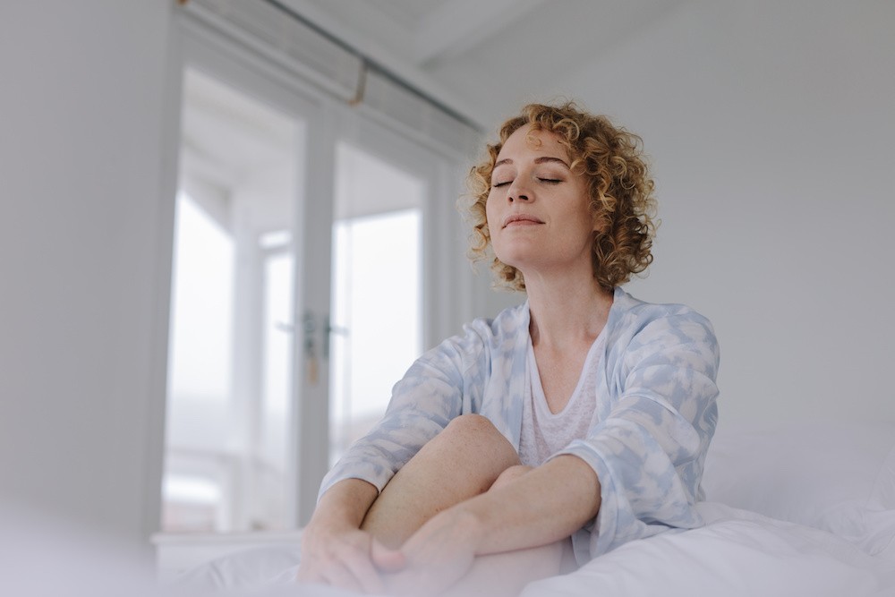 Woman in bed, feeling at home at a residential recovery center in Malibu, California.