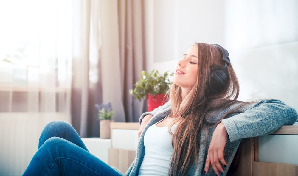 Woman listening to music through her headphones, once the party stops how to get treatment for club drugs.