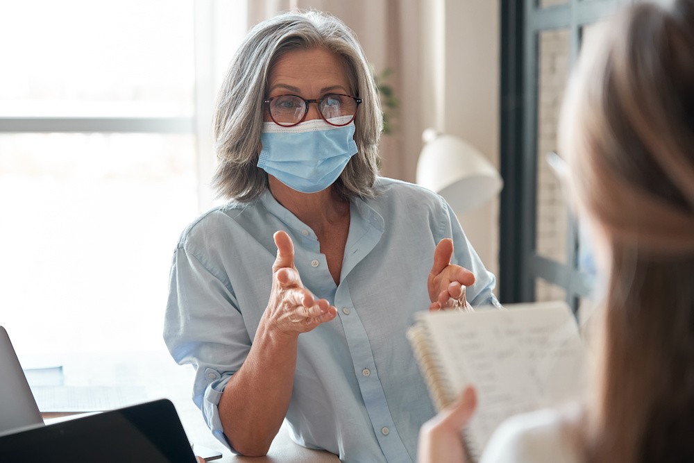 Woman in mask, COVID-19 and addiction treatment.