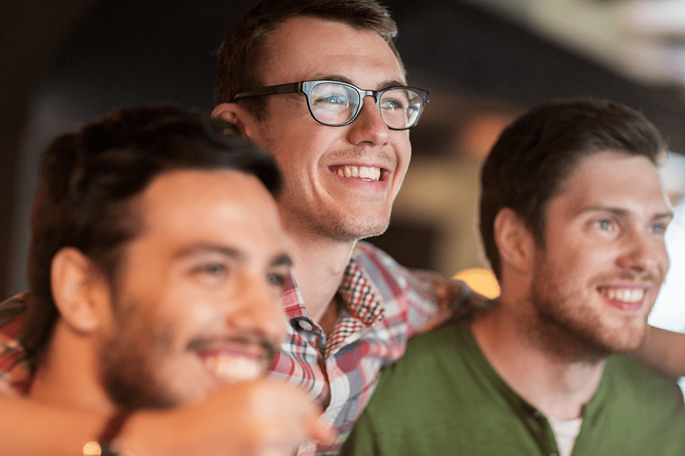 Men and addiction recovery, three men having a good time and smiling.