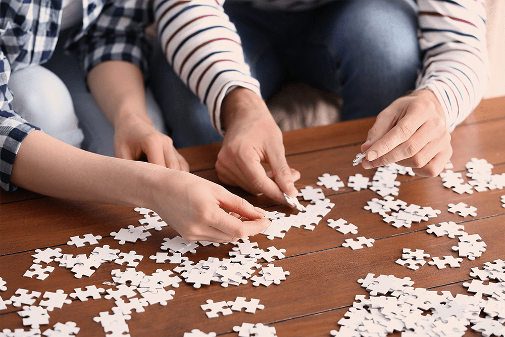 Mental health fitness, two people putting together a puzzle.