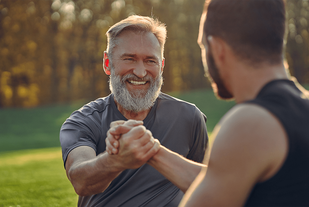 Two men in the park after a work out discussing whether or not they will be 'in recovery' for the rest of their lives and what that looks like.