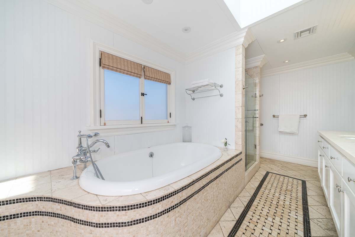 Large bathroom with white tub and shower in Cliffside Malibu, a residential treatment center in Malibu, California.