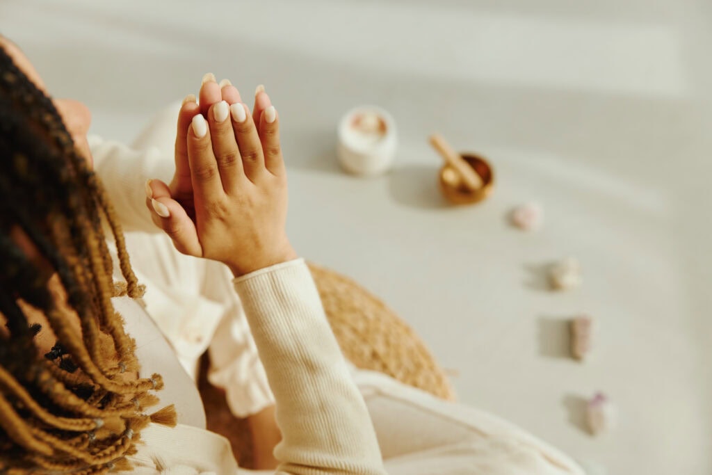 Closeup of female hands in namaste pose during meditation.